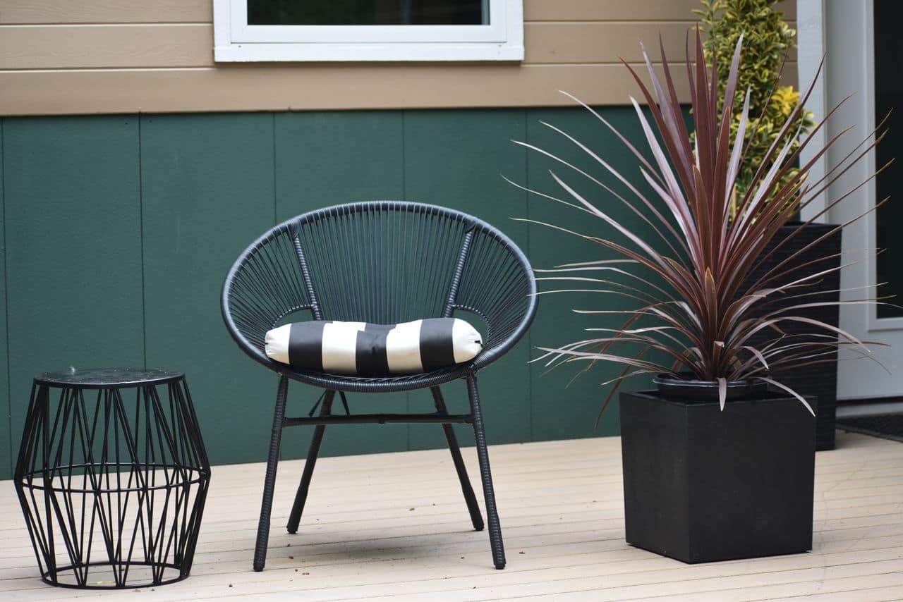 Covered tropical alfresco area with timber deck beside a pool